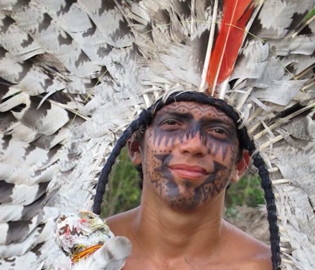 Yawanawá teen wearing a headdress of Harpy Eagle feathers
