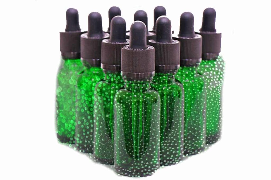 Dropper bottles containing green sparkly liquid. How to make ayahuasca vine extract for microdosing.